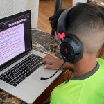 young boy having online tuition