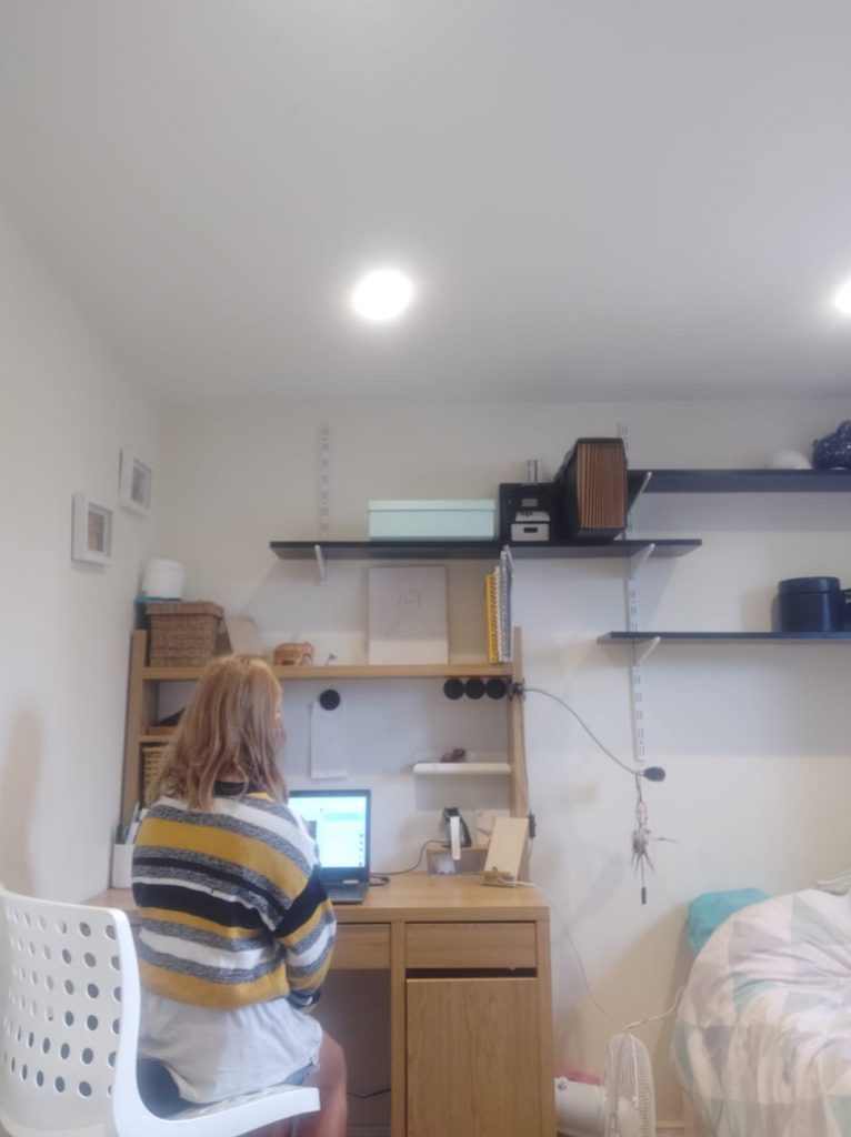 Young girl sitting at the desk engaging in a 11+ online tutoring session with Bettering Youth